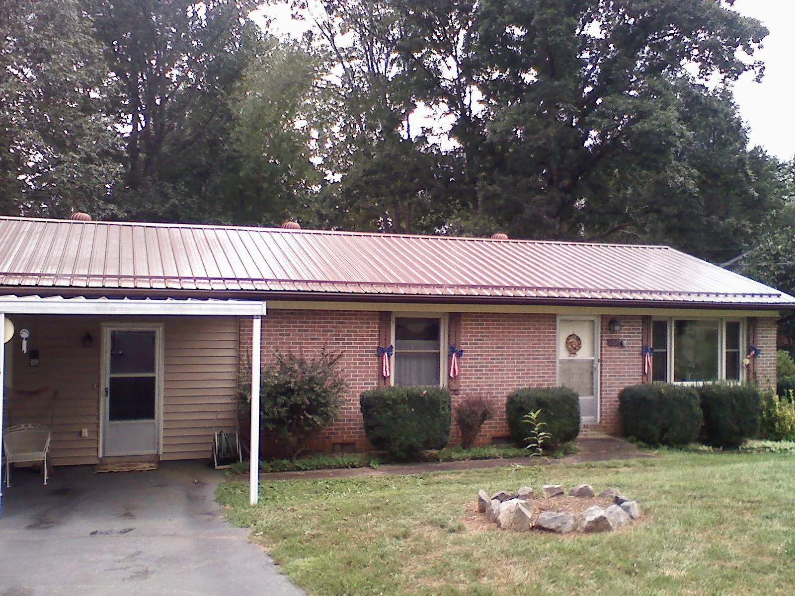 Bronze metal roof and carport on a brick ranch home — Roof Repair work by our crew in Elmwood Park